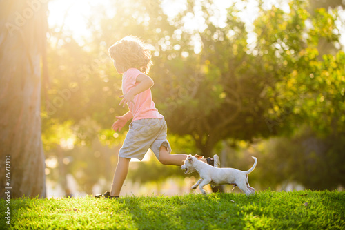 Canvas Print Boy child walk with puppy