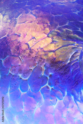 closeup macro of patterns textures colors in a handmade glass globe ornament glasswork craft