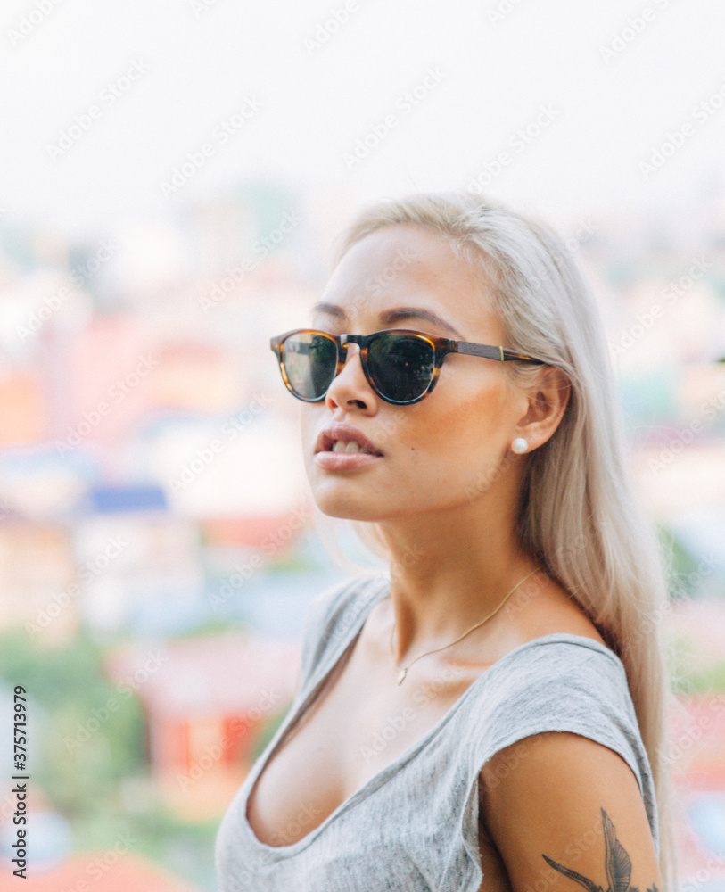 Young asian female model wears glasses on rooftop