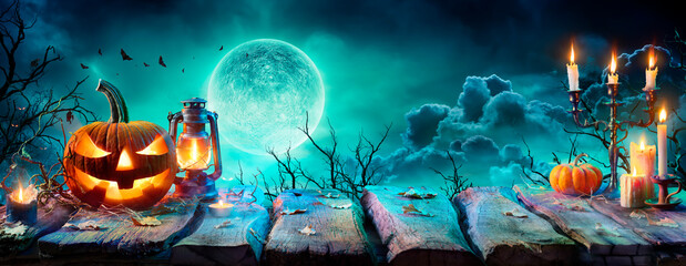 Jack O’ Lantern On Table In Spooky Night - Halloween With Full Moon
