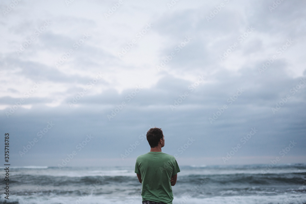 Man with looking out at ocean thinking - alone Man with looking out at ocean thinking - alone