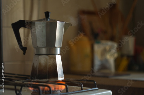 Old geyser coffee maker on the gas stove in the kitchen.