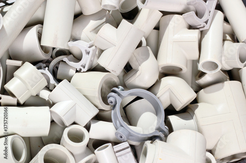 Parts of plastic piping and fitting as plumbing background.