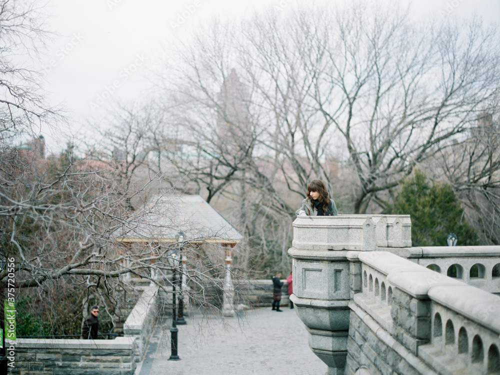 Woman sitting on building in Central Park Woman sitting on building in Central Park