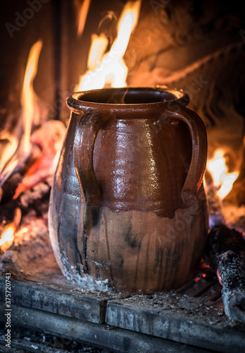 Cooking in Clay pot on the fire photo