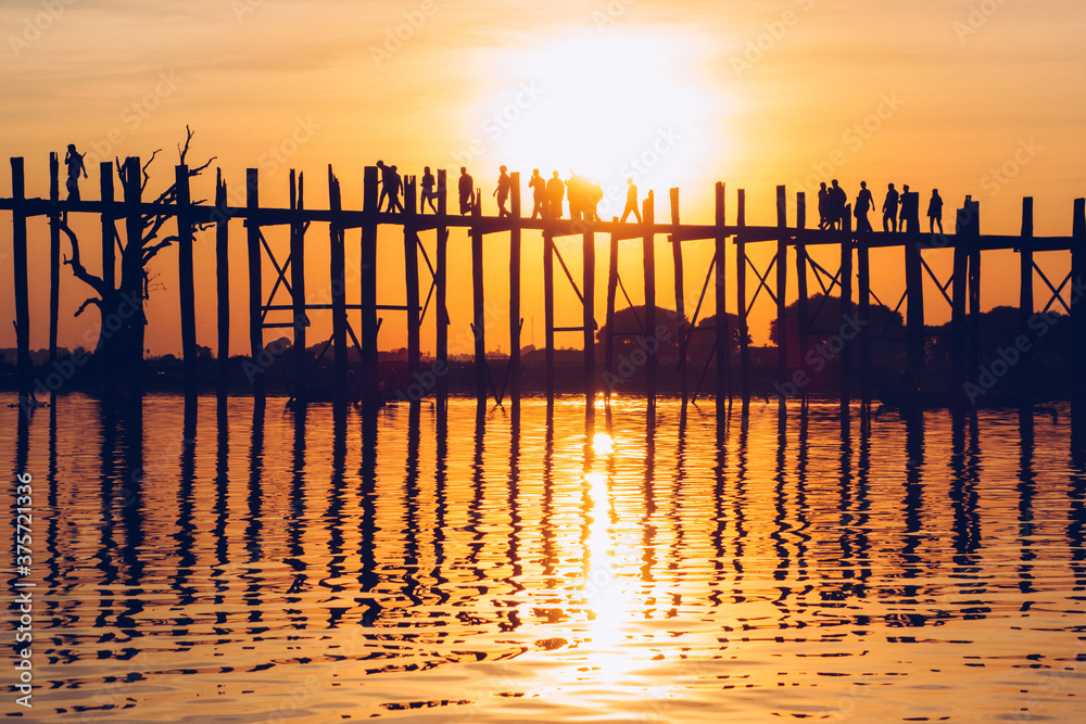Orange Sundown Behind Long Wooden Bridge in Mandalay, Burma Orange Sundown Behind Long Wooden Bridge in Mandalay, Burma