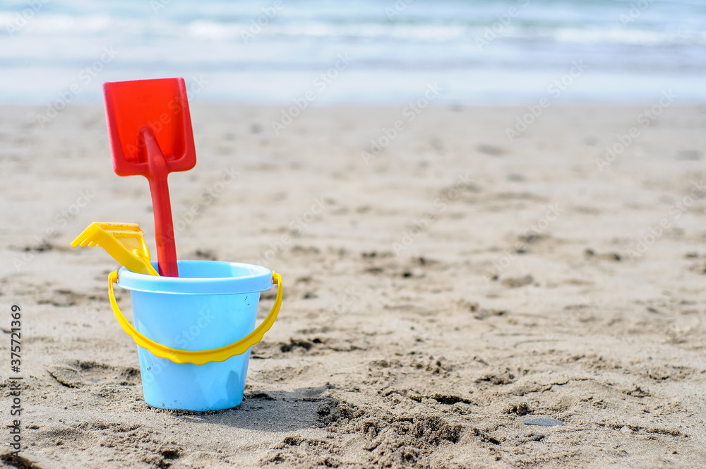 Rake shovel bucket on the beach Rake shovel bucket on the beach