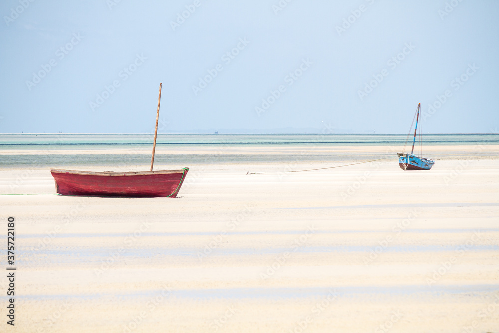 Red and blue traditional sailboats on a lonely beach. Vilanculos, Mozambique Red and blue traditional sailboats on a lonely beach. Vilanculos, Mozambique
