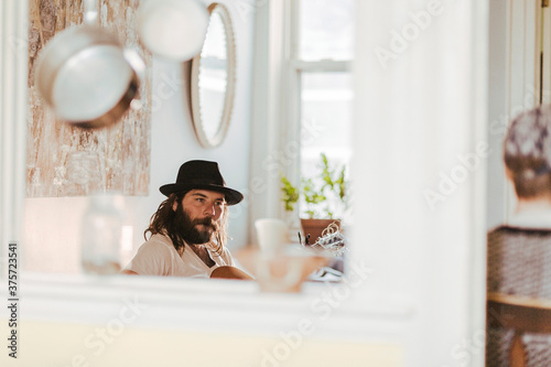 Talented soulful musician strums his guitar as he relaxes at home photo