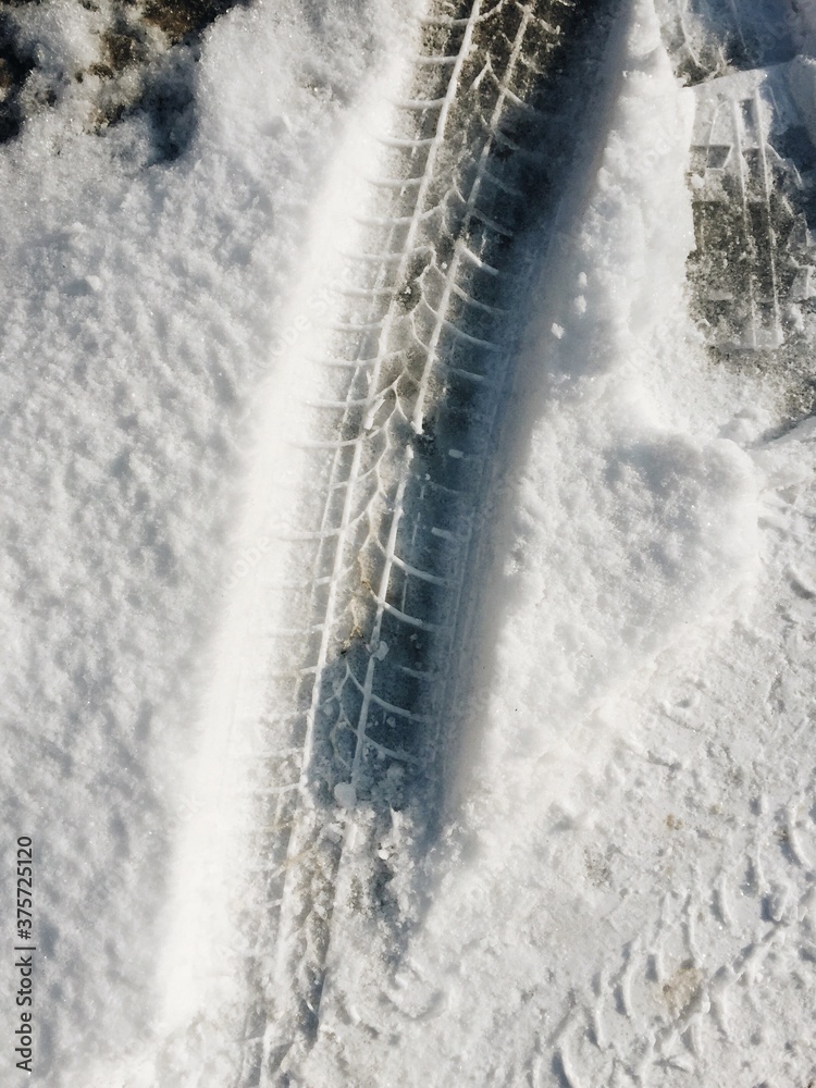 Footprints and car tracks on the city streets Footprints and car tracks on the city streets
