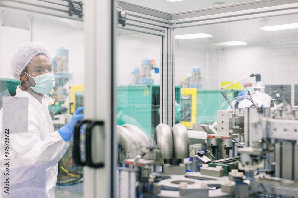 Male engineer working in a factory. Male engineer working in a factory.