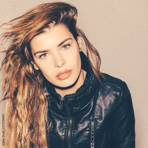 Young woman in leather jacket and messy hair