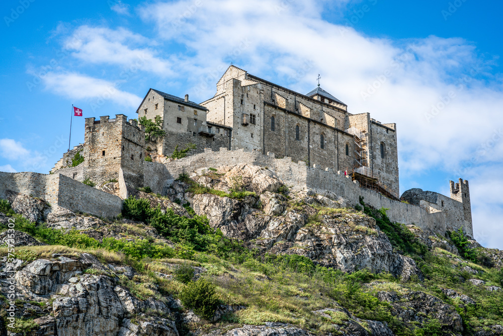 Fototapeta premium The Valere basilica close-up scenic view on rocky hill with clear blue sky in Sion Switzerland