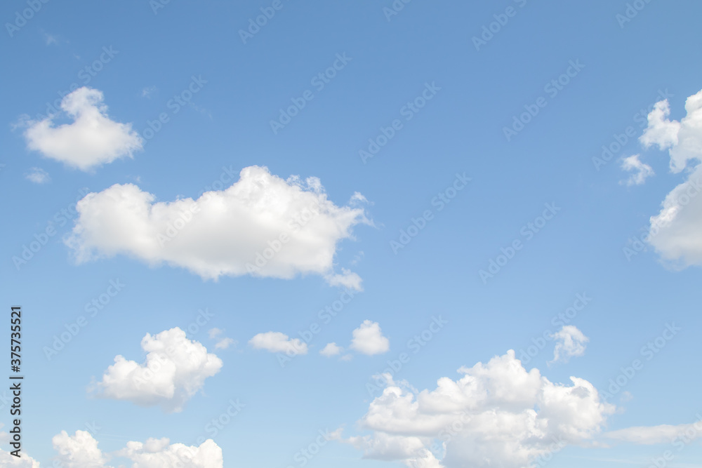 White fluffy clouds against a bright blue sky.