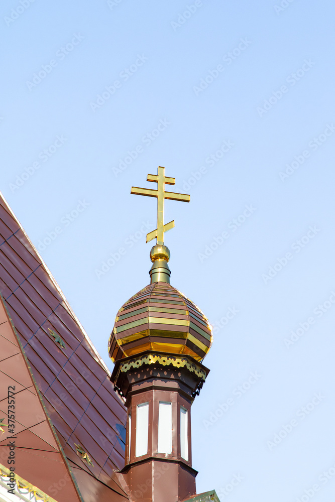 Golden crosses of the Orthodox Church against the sky.