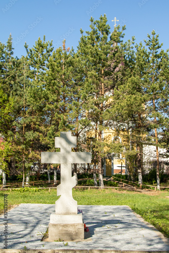 Golden crosses of the Orthodox Church in the green leaves of a tree, out of focus. Golden crosses of the Orthodox Church in the green leaves of a tree, out of focus.