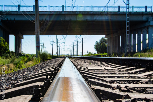 Railway rails pillars, infrastructure, nature summer.