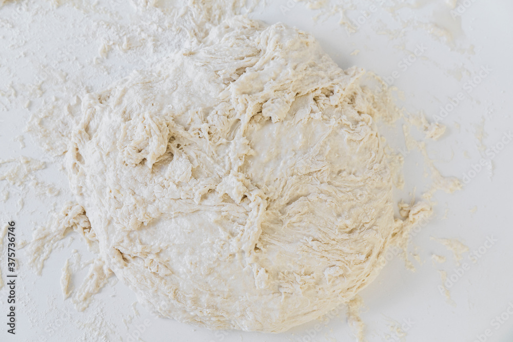 Big pile of plain dough on a white surface Big pile of plain dough on a white surface
