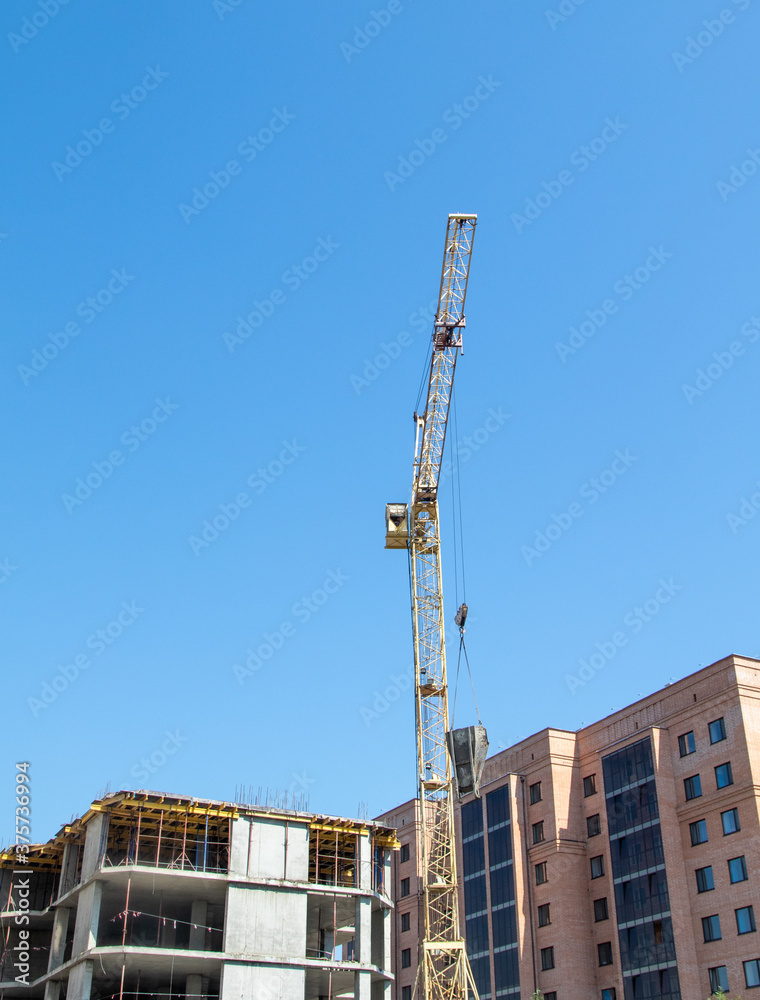 The construction of a multi-storey building, the operation of a tower crane, the frame of the house. The construction of a multi-storey building, the operation of a tower crane, the frame of the house.