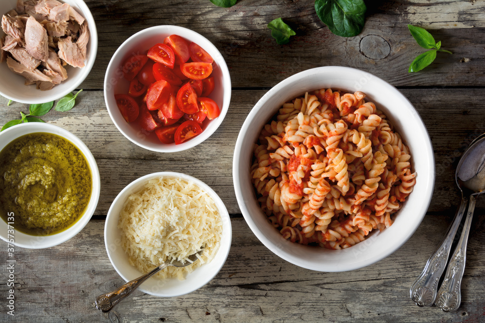 Pasta with various additions in bowls Pasta with various additions in bowls