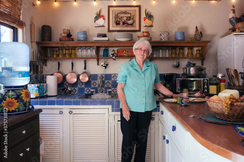 Healthy and happy 87 year old woman in her kitchen. photo