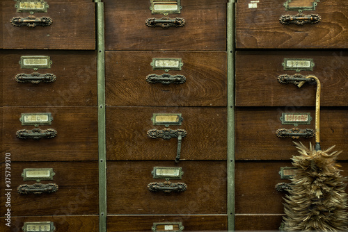 Drawers of an apothecary chest with a duster photo