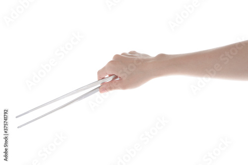 hands holding steel tweezers.