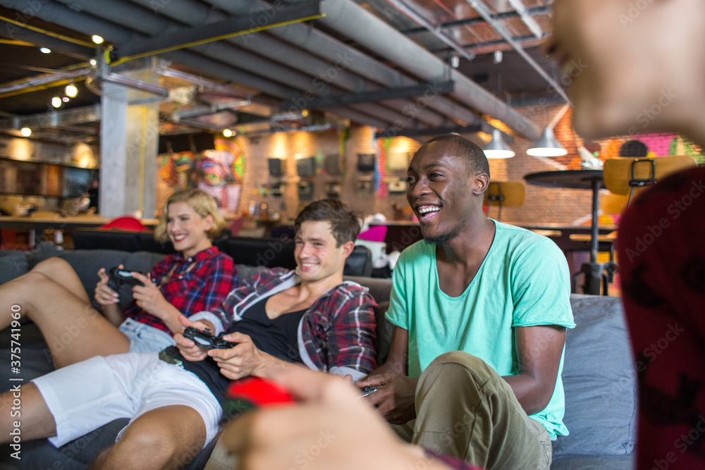 Group of friends playing video games and having fun together Group of friends playing video games and having fun together