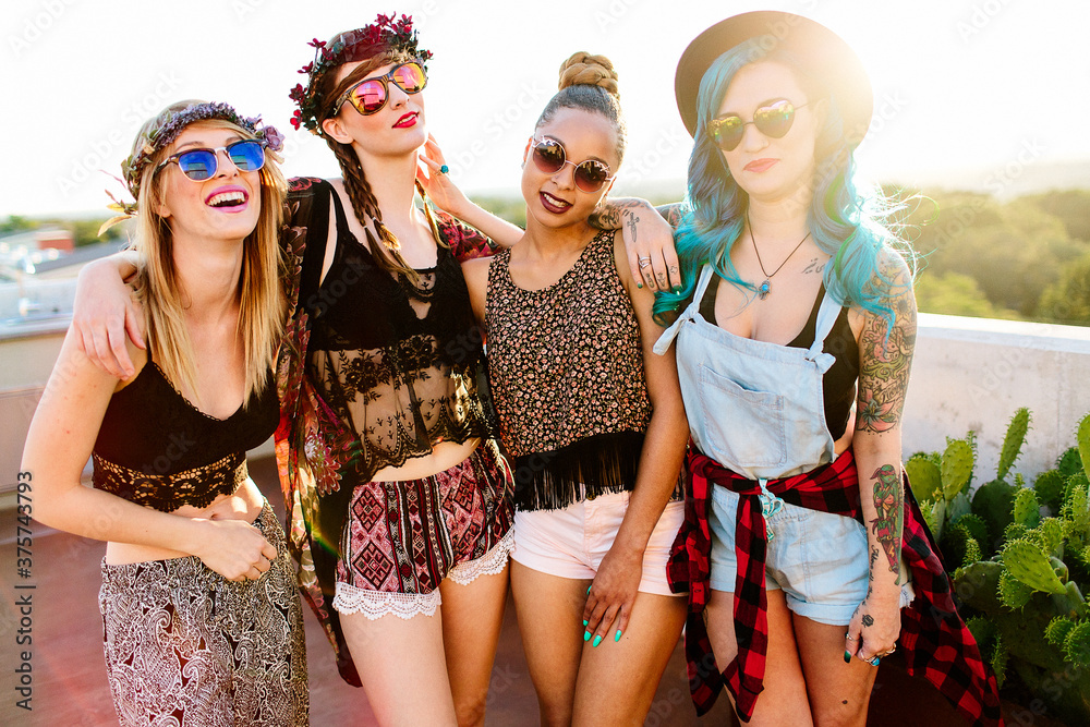 A group of girl friends hanging out outdoors in the sunlight A group of girl friends hanging out outdoors in the sunlight