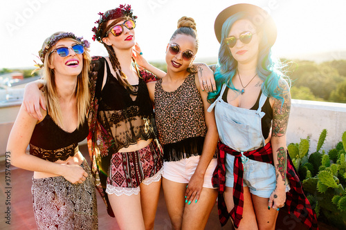 A group of girl friends hanging out outdoors in the sunlight