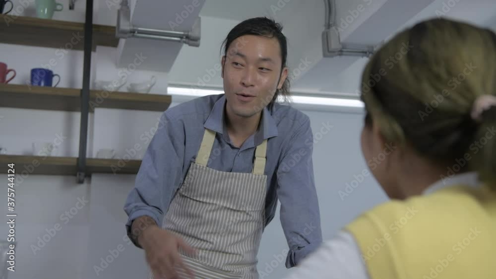 Coffee shop concept. The waitress spoke comfortably with customers in the coffee shop. 4k Resolution. Coffee shop concept. The waitress spoke comfortably with customers in the coffee shop. 4k Resolution.