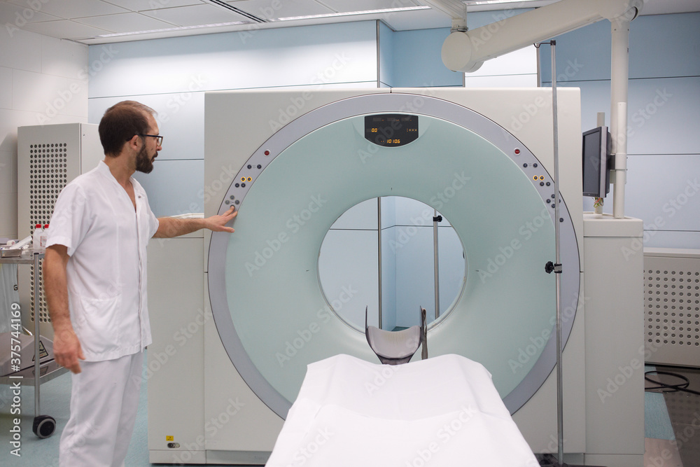 CT scan and technician preparing turning on the equipment CT scan and technician preparing turning on the equipment