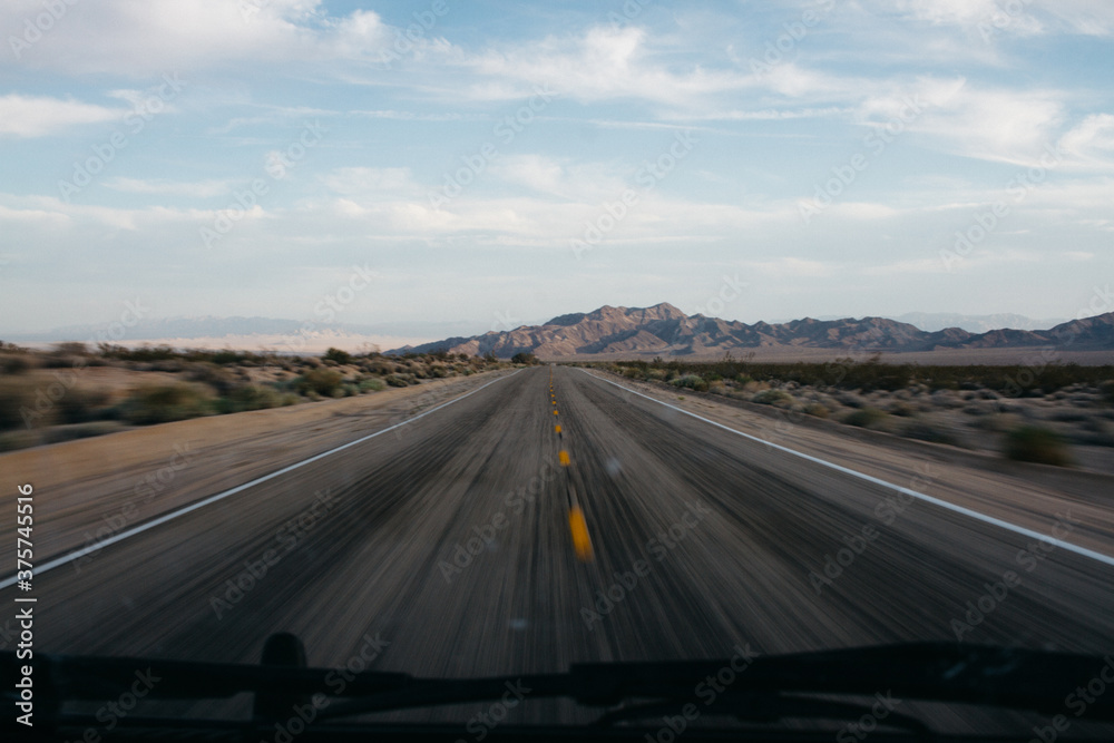 photo out of front window of car during road trip photo out of front window of car during road trip