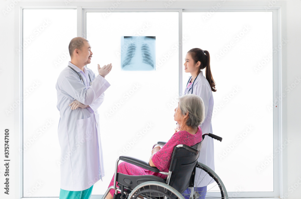 two Asian doctor looking patient film, they talk about symptoms and treatment plan of patient, they explain about disease with old patient, broken bone treatment, tuberculosis screening two Asian doctor looking patient film, they talk about symptoms and treatment plan of patient, they explain about disease with old patient, broken bone treatment, tuberculosis screening