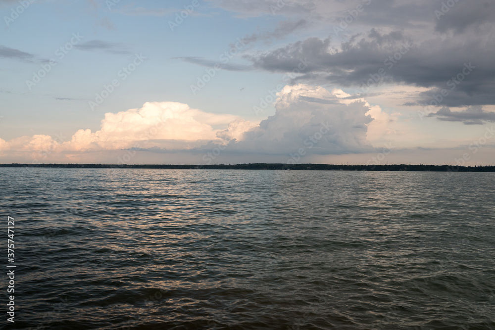 sunset over the sea during cloudy weather with vibrant and calm sky sunset over the sea during cloudy weather with vibrant and calm sky