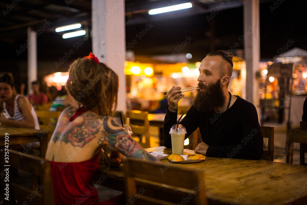 Couple Having Dinner in a Street Restaurant Couple Having Dinner in a Street Restaurant