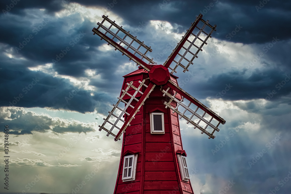 Red windmill against a stormy, dramatic sky.  From Gangneung, South Korea
