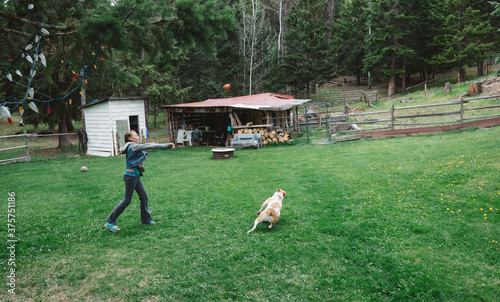 Girl Plays Fetch With Dog photo