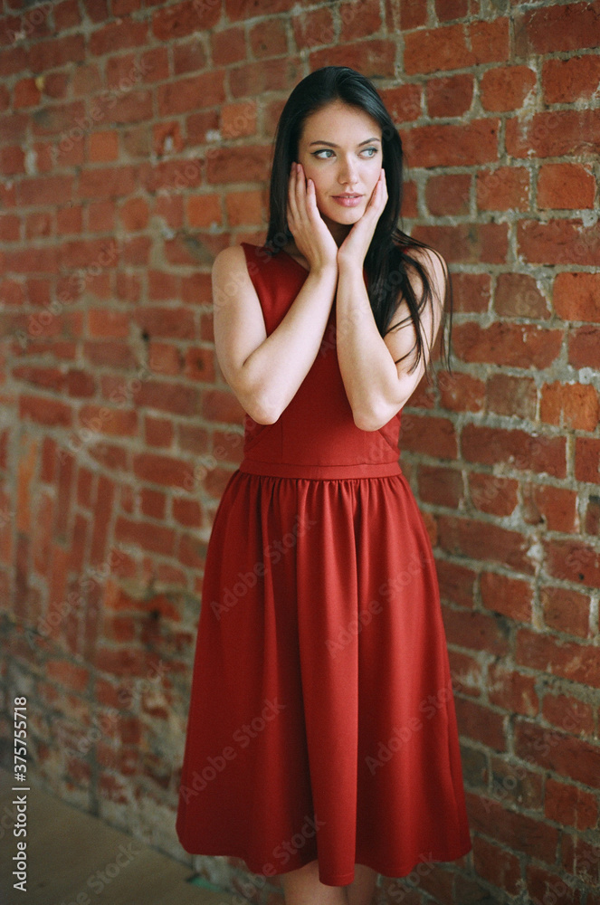 Beautiful woman against brick wall