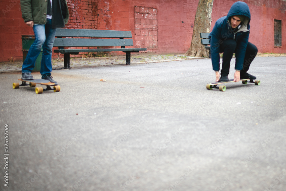 Mexican-American Young Men Friends in Brooklyn Playground with Skateboard Mexican-American Young Men Friends in Brooklyn Playground with Skateboard
