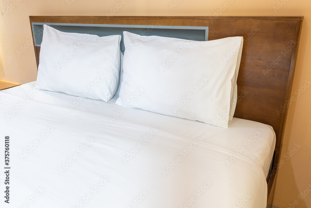 White pillows on a bed Comfortable soft pillows on the bed. White pillows on a bed Comfortable soft pillows on the bed.