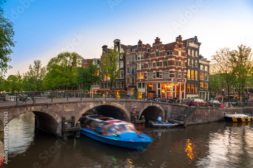 Photography Amsterdam Canal Bridge Tour boat Buildings at night just after sunset with light