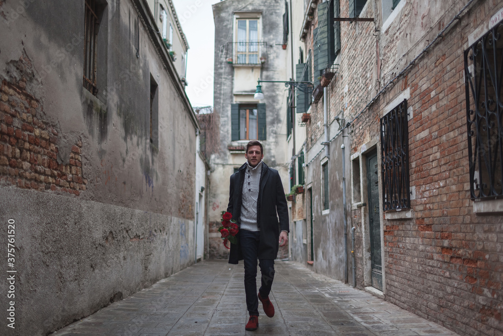 Man Walking With Red Roses Bouquet in Venice Man Walking With Red Roses Bouquet in Venice