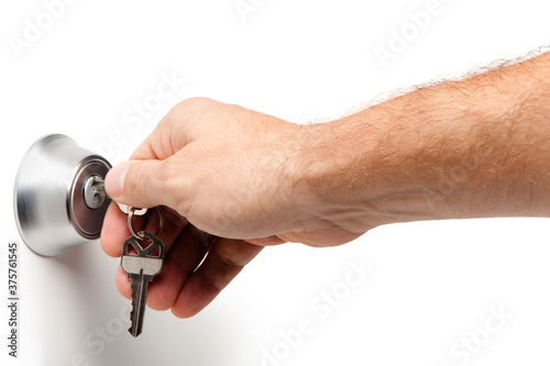 Man's arm locking unlocking opening closing household deadbolt lock with keys isolated on white background