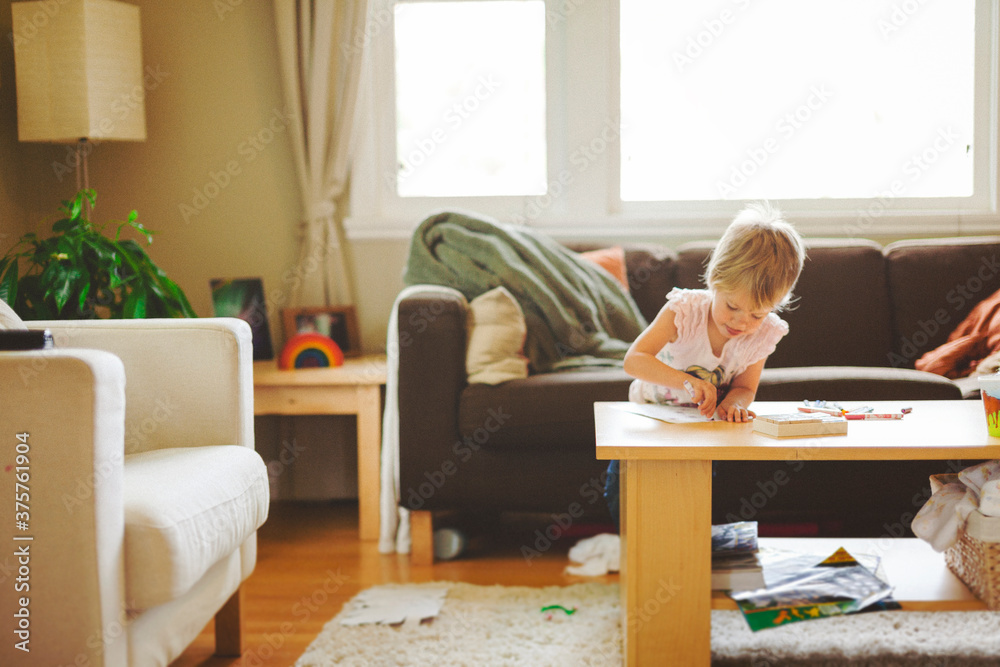 Cute toddler girl colouring a picture at home Cute toddler girl colouring a picture at home