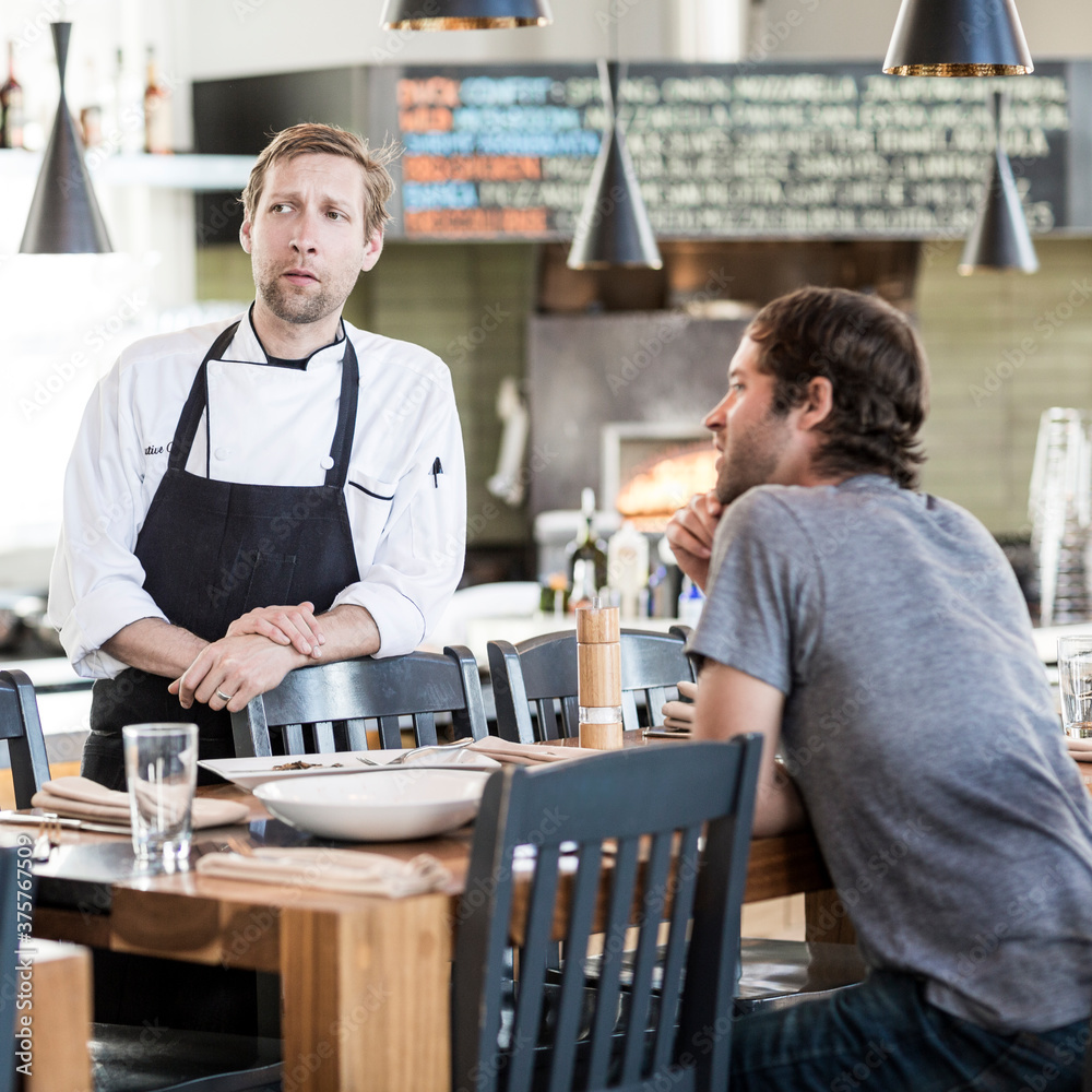 Chef and shift manager conversing after a meal Chef and shift manager conversing after a meal