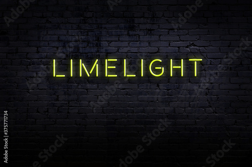 Fotografie Night view of neon sign on brick wall with inscription limelight