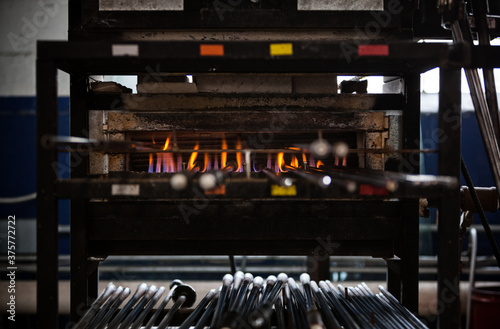 Glass: Blowpipes In Pipe Warmer Waiting To Be Used For Glass Blo