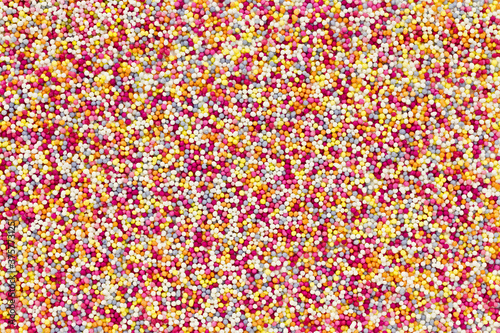Colourful round sweet sprinkles overhead (hundreds and thousands)