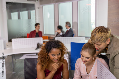 Diverse ethnicities in a business office. Workers from different races discuss and support each other for great success. Gender equality in private office